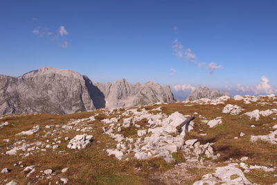 Scenic view of mountains against blue sky