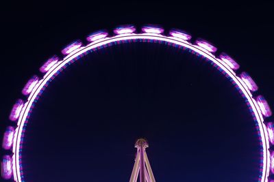 Low angle view of illuminated ferris wheel