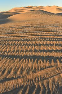 Scenic view of desert against sky during sunset