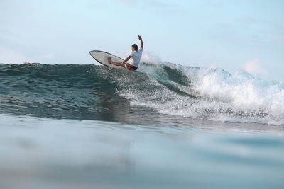 Surfer on a wave, lombok, indonesia