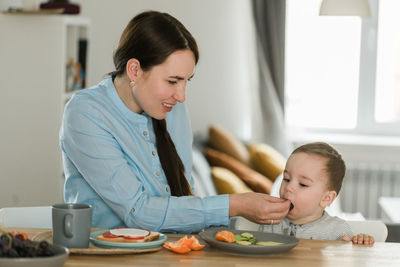 Side view of boy using digital tablet at home