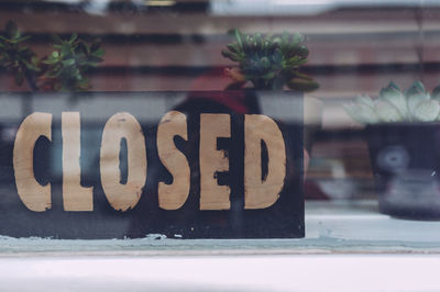 Close-up of closed sign in store window