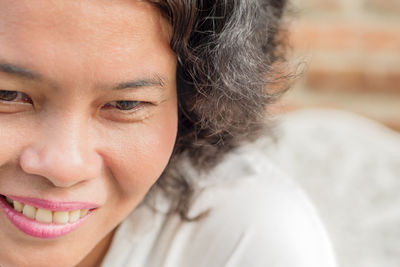 Close-up portrait of a smiling young woman