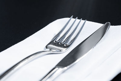 Close-up of piano on table against black background