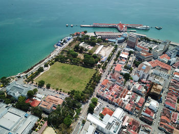 High angle view of buildings and sea in city