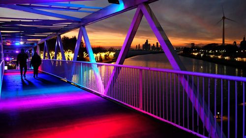 People walking on bridge at night