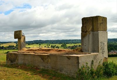 Tombstones in cemetery against sky