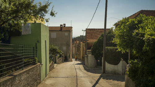 Street amidst buildings against sky