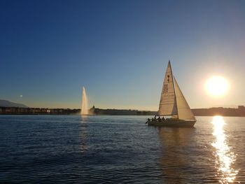 Ship sailing in sea against clear sky