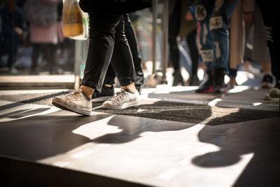 Low section of people walking on street