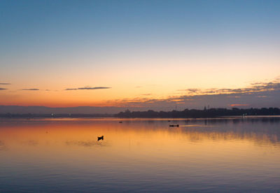 Scenic view of lake against sky during sunset