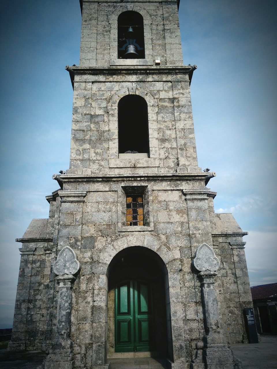 architecture, built structure, building exterior, low angle view, religion, history, sky, arch, tower, church, old, place of worship, window, cross, facade, clock tower, day, spirituality