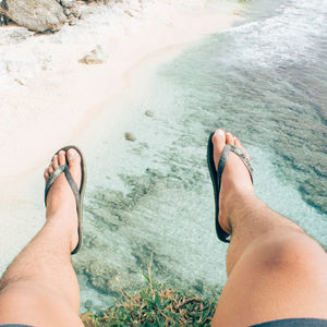 Low section of woman relaxing on beach