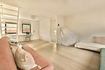 Rear view of woman sitting on bed at home