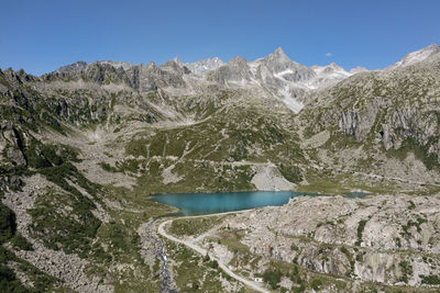 Scenic view of snowcapped mountains against clear blue sky