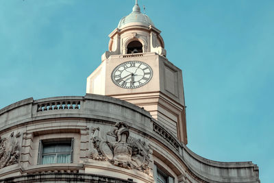 Low angle view of clock tower against sky