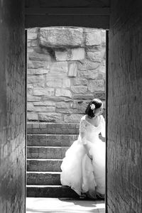 Rear view of woman standing against door