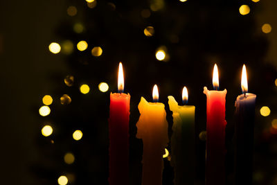 Close-up of lit candles in the dark