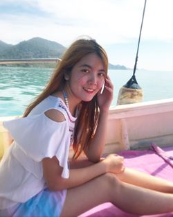 Portrait of smiling young woman in water