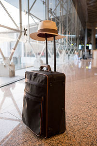 Hat on suitcase at airport