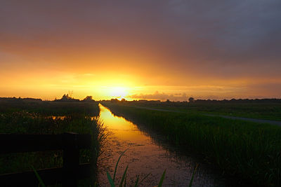 Scenic view of field against sky during sunset