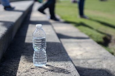 Close-up of water bottle on staircase