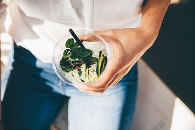 Midsection of woman holding drink