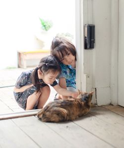 Girl sitting by cat