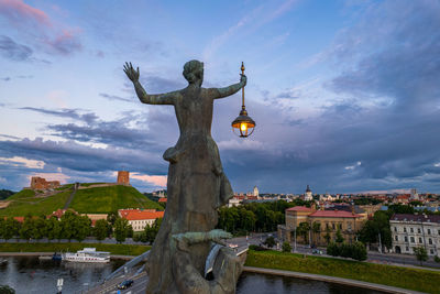 Low angle view of woman standing by lake