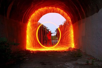 Illuminated tunnel at night