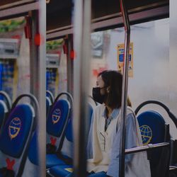 Rear view of woman looking at train