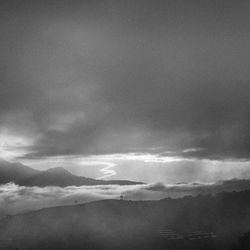 Low angle view of clouds over mountain