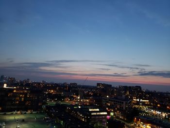 High angle view of illuminated buildings against sky at sunset