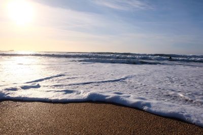 Scenic view of beach against sky during sunset