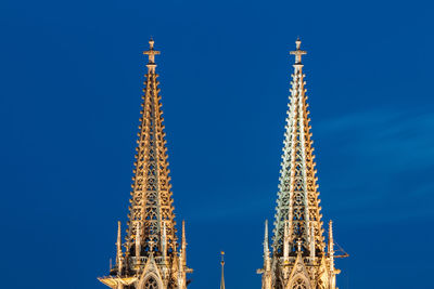 Low angle view of communications tower against blue sky