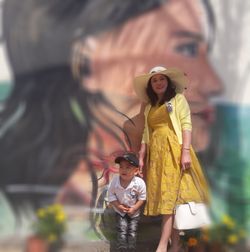 Full length of father and daughter standing outdoors