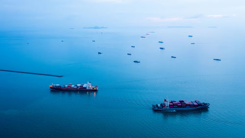 Boats in sea against sky