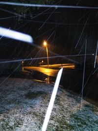 Blurred motion of illuminated bridge against sky at night