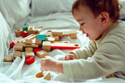 Close-up of baby girl playing with toy at home