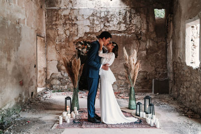 Couple standing on floor by wall