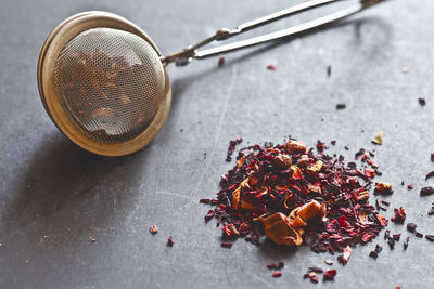 Tea infuser with dried flowers on table