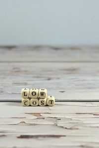 Close-up of text on table against sea