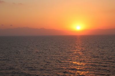 Scenic view of sea against romantic sky at sunset