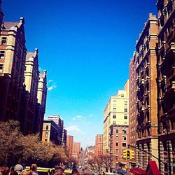 Buildings in city against blue sky