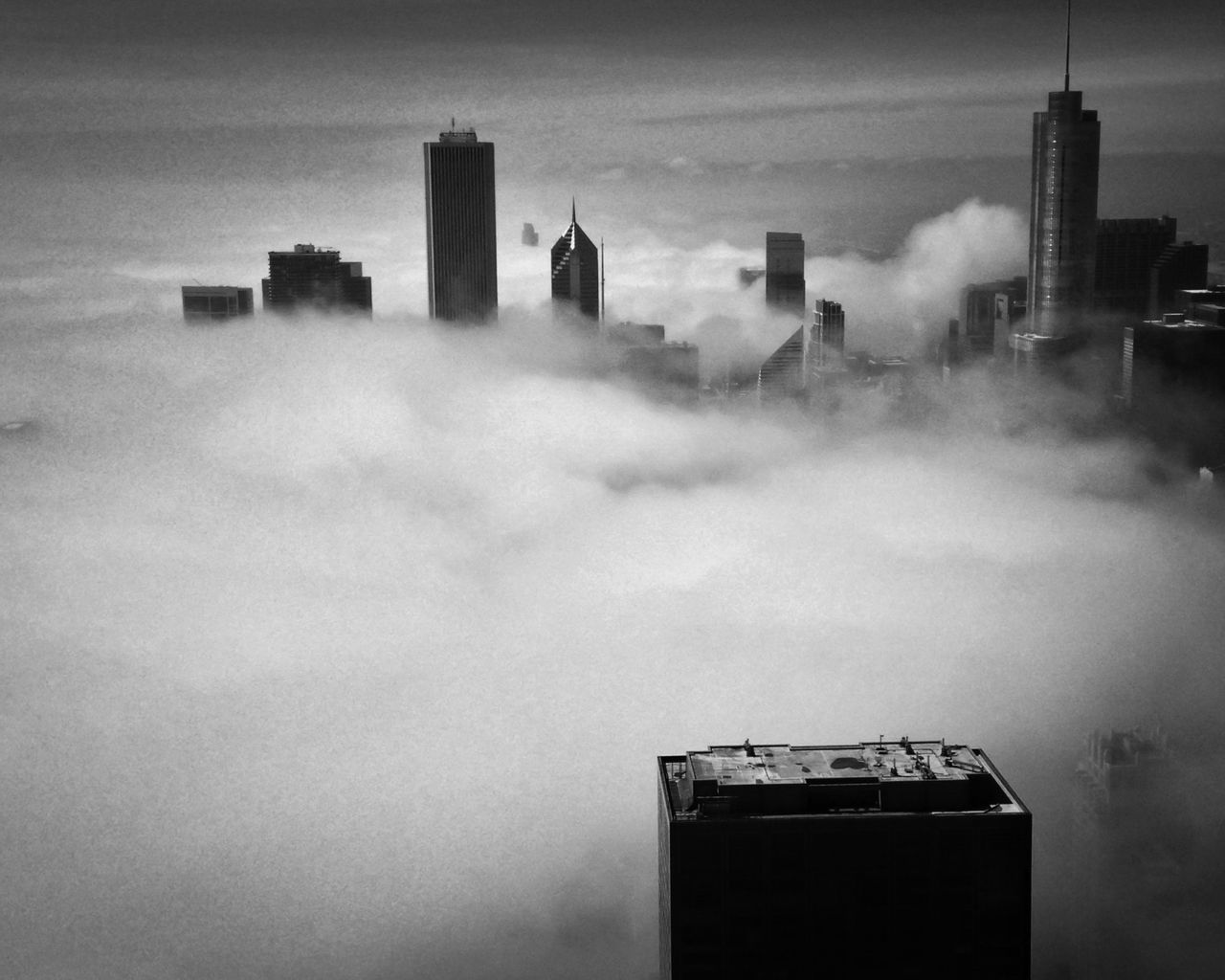 building exterior, architecture, built structure, skyscraper, city, sky, tall - high, tower, modern, cloud - sky, weather, office building, building, sunset, urban skyline, no people, smoke stack, outdoors, dusk, fog