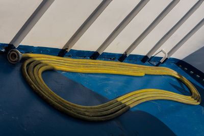 Large yellow cable on blue floor