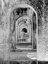 Woman standing in old building