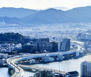 High angle view of buildings and sea in city