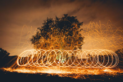 Close-up of light painting against sky