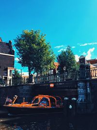 Cars on bridge in city against sky